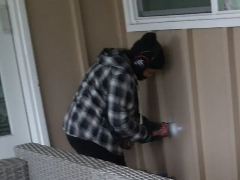 Professional electrician installing an exterior outlet in Holts Summit